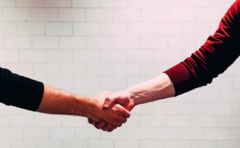 A recruiter shaking hands with a candidate