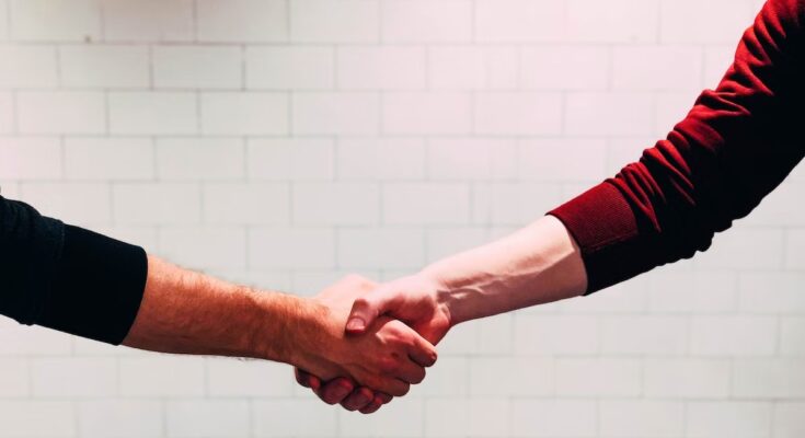 A recruiter shaking hands with a candidate